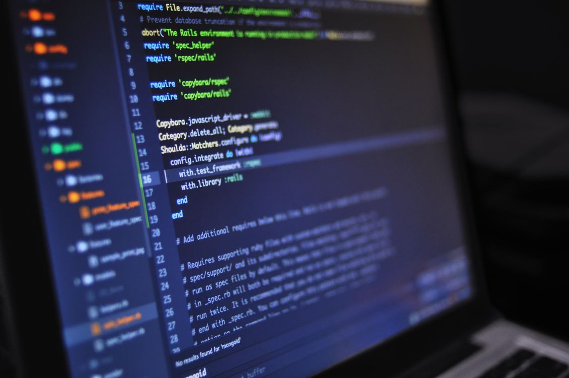 Close-up of programming code on a dark monitor screen