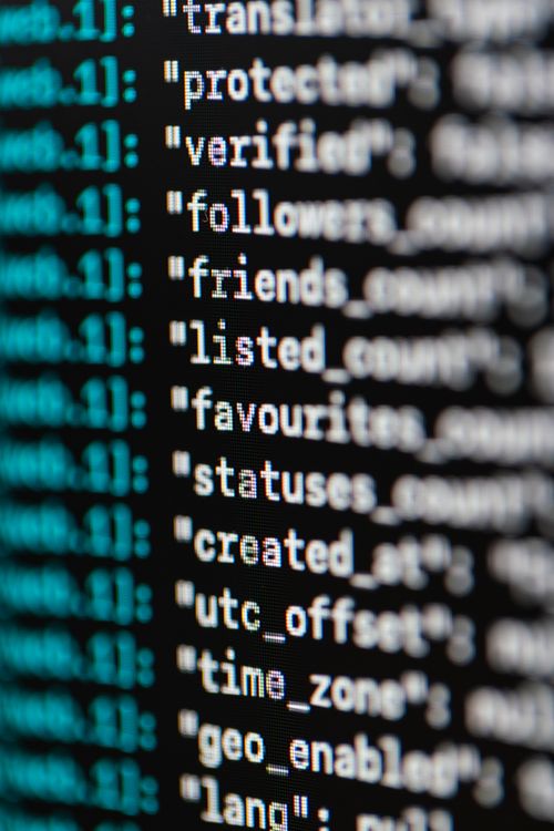 Extreme close-up of programming code on a screen showing various technical elements