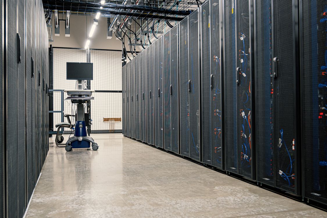 Server racks in a modern data centre with network cabling