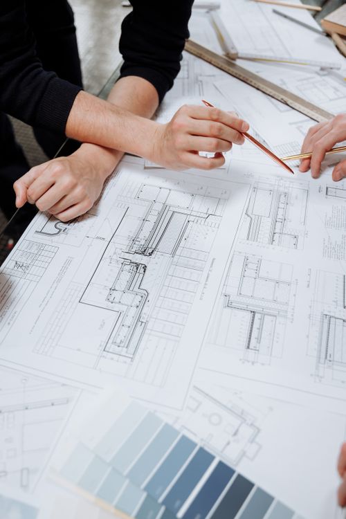 Engineer reviewing a schematic diagram and planning system architecture